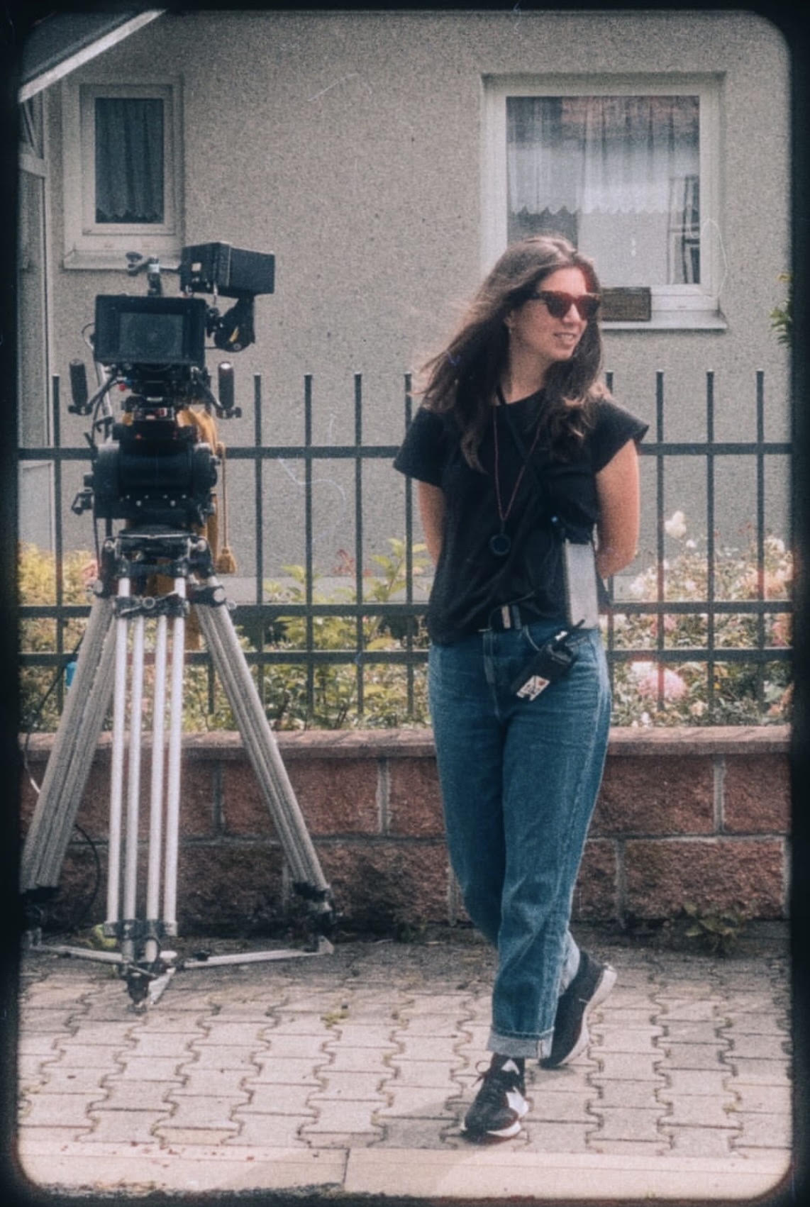 Jana Hojdová standing beside a cinema camera